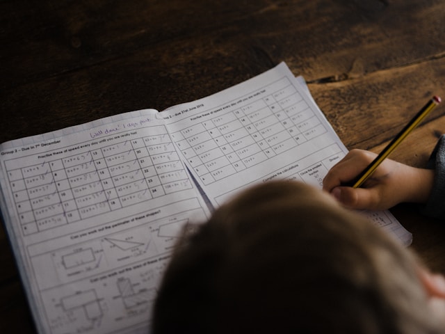 “Child completing a multiplication worksheet—building foundational skills through visual learning at James An College Eastwood.”