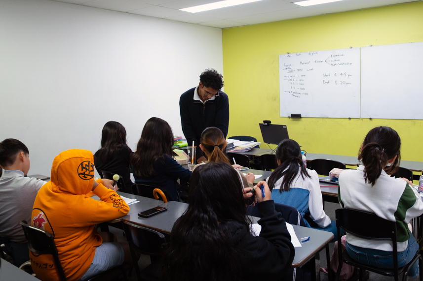 Classroom scene with students engaged and a teacher providing guidance at the front, illustrating an emotionally supportive learning environment to help children.