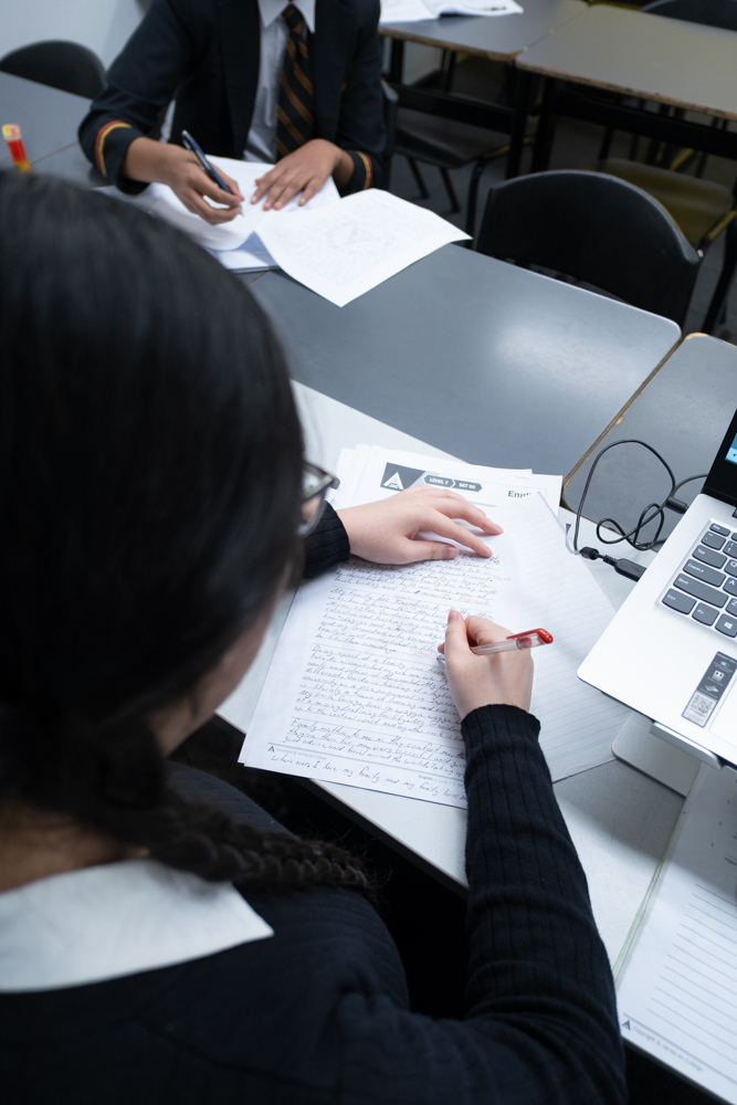 “Focused student drafting a written response during English tutoring at James An College.” How to Help Them Answer Questions Effectively
